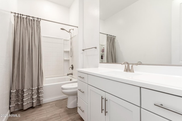 bathroom featuring toilet, wood finished floors, vanity, and shower / bathtub combination with curtain