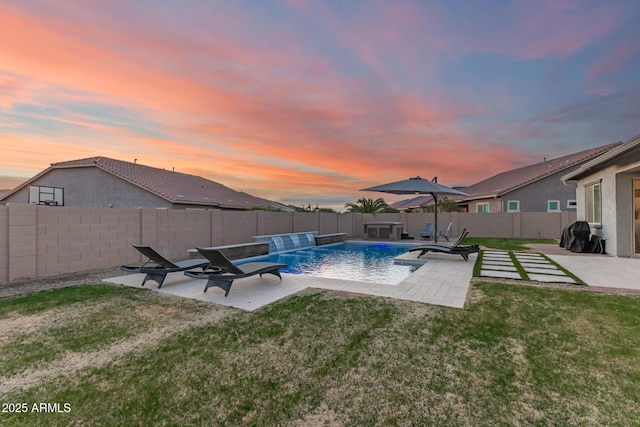 view of swimming pool featuring a patio, a yard, a fenced backyard, and a fenced in pool