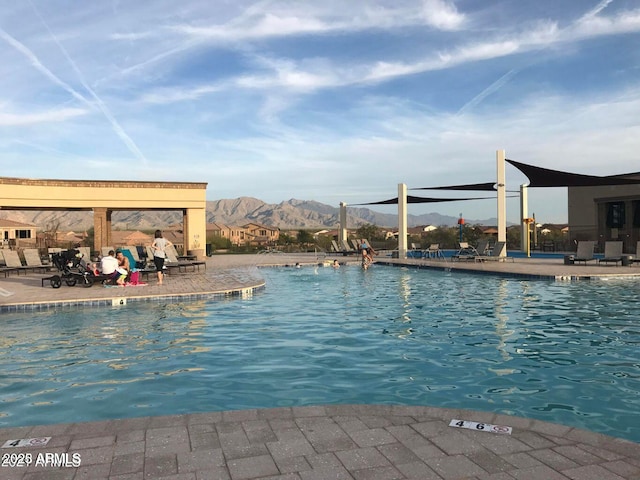 view of swimming pool with a mountain view and a patio area