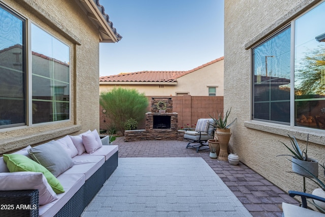 view of patio / terrace featuring an outdoor living space with a fireplace