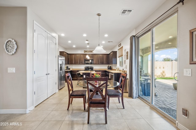 dining area with sink and light tile patterned floors