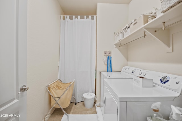 washroom with separate washer and dryer and light tile patterned floors