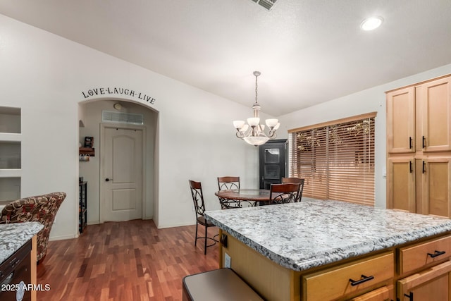 kitchen with a chandelier, dark wood-style floors, vaulted ceiling, decorative light fixtures, and recessed lighting