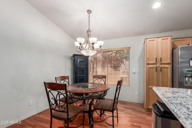 dining area with a chandelier, light wood-style flooring, vaulted ceiling, baseboards, and recessed lighting