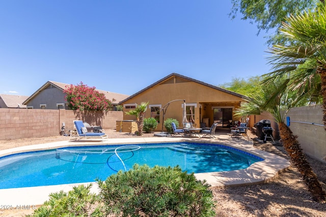 view of swimming pool featuring a patio and a fenced backyard