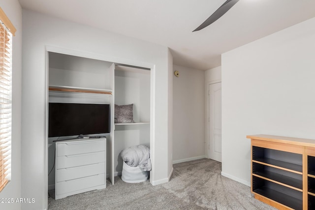 unfurnished bedroom featuring carpet floors, baseboards, and a closet