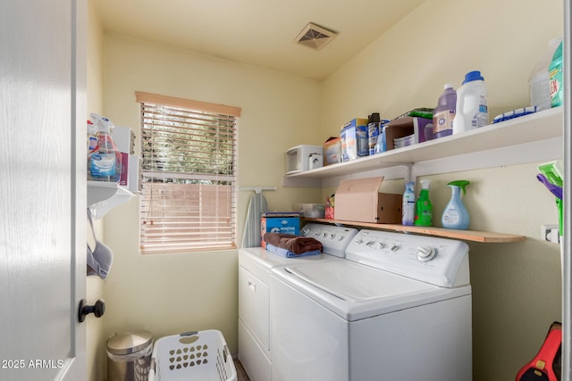 clothes washing area featuring washer and dryer