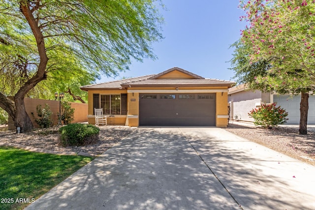 single story home featuring concrete driveway, a tiled roof, stucco siding, fence, and a garage