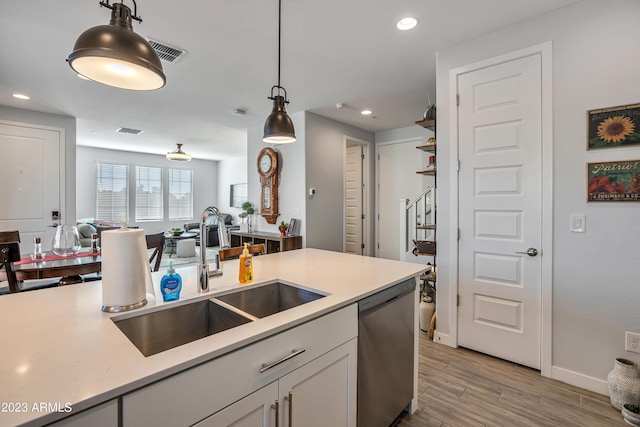 4100 S Pinelake Way Unit 149, Chandler, AZ 85249 - kitchen with dishwasher, open floor plan, hanging light fixtures, light countertops, and light wood-type flooring