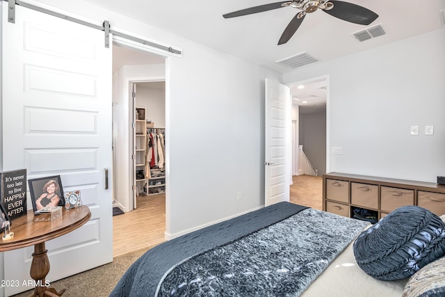 4100 S Pinelake Way Unit 149, Chandler, AZ 85249 - bedroom with a barn door, carpet, a spacious closet, and recessed lighting