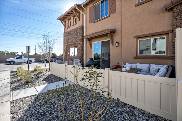 4100 S Pinelake Way Unit 149, Chandler, AZ 85249 - view of property exterior featuring stucco siding, an outdoor hangout area, and stone siding