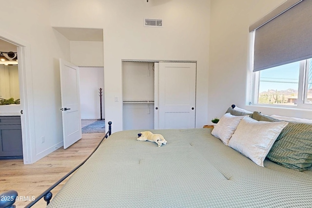 bedroom with light wood-style flooring and a closet