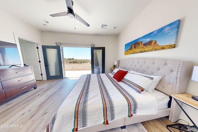 bedroom with access to exterior, light wood-style floors, and ceiling fan