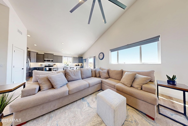 living room with high vaulted ceiling, ceiling fan, and recessed lighting
