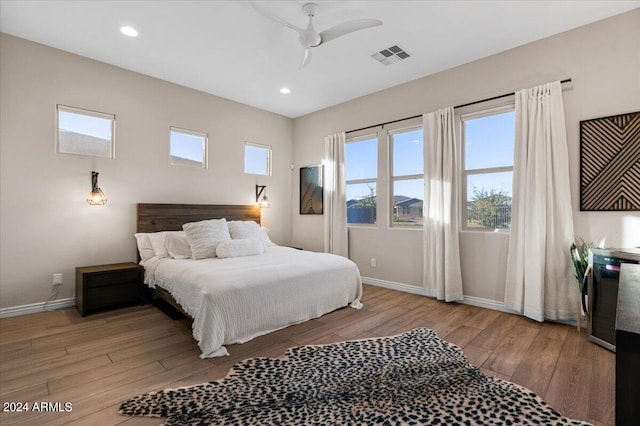 bedroom with light hardwood / wood-style floors and ceiling fan