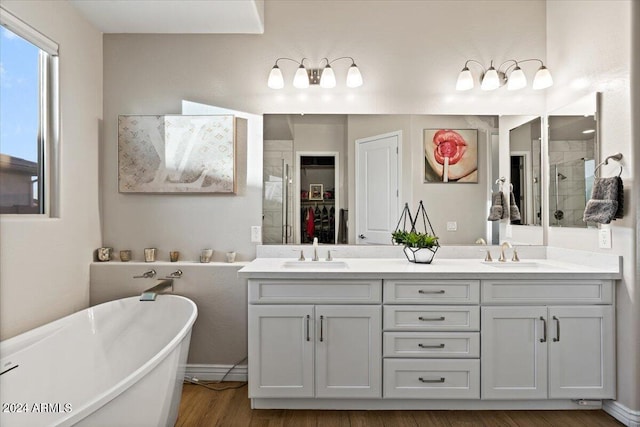 bathroom featuring independent shower and bath, vanity, and hardwood / wood-style flooring