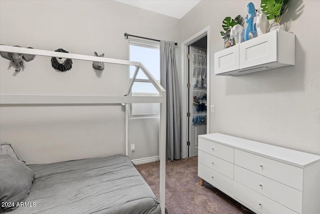 bedroom featuring dark colored carpet