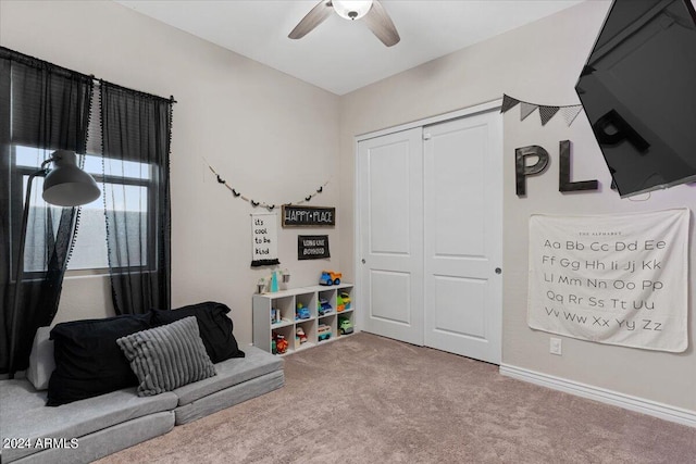 recreation room with carpet flooring and ceiling fan