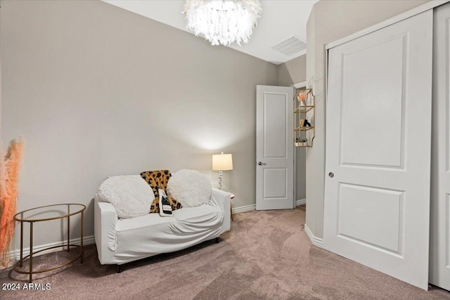 living area with an inviting chandelier and carpet