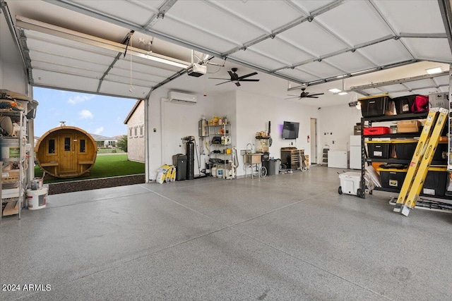 garage featuring ceiling fan, a garage door opener, white fridge, and a wall unit AC