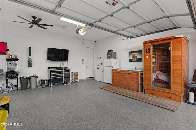 garage featuring a garage door opener, ceiling fan, and white fridge