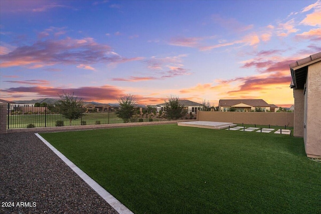 yard at dusk with a patio area