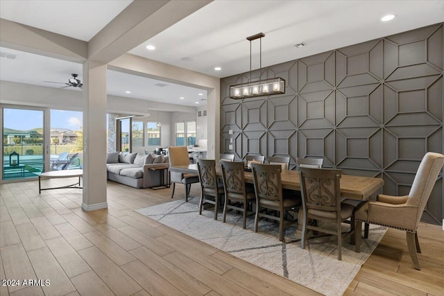 dining space with ceiling fan and light hardwood / wood-style flooring