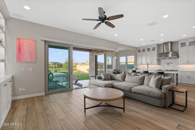 living room featuring light hardwood / wood-style floors and ceiling fan