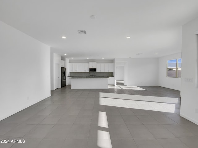 unfurnished living room featuring light tile patterned flooring