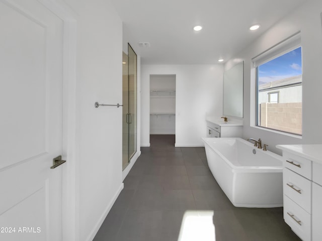 bathroom featuring tile patterned flooring, vanity, and independent shower and bath