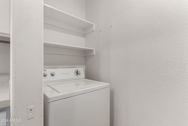 clothes washing area featuring washer / dryer