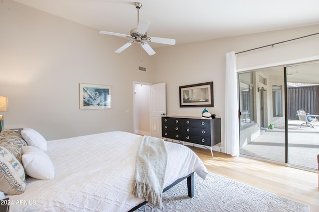 bedroom with access to exterior, ceiling fan, lofted ceiling, and hardwood / wood-style flooring