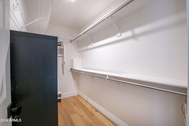 spacious closet with light hardwood / wood-style floors