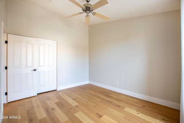 unfurnished bedroom with light hardwood / wood-style floors, a closet, and ceiling fan