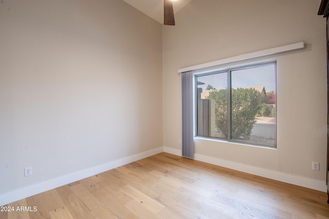 unfurnished room featuring vaulted ceiling and light wood-type flooring