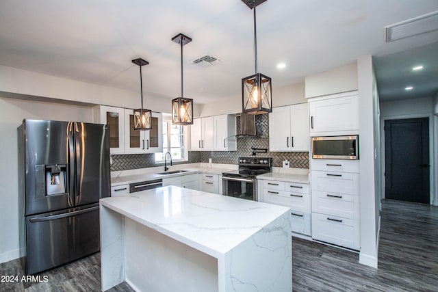 kitchen featuring light stone counters, white cabinetry, stainless steel appliances, dark hardwood / wood-style floors, and a center island