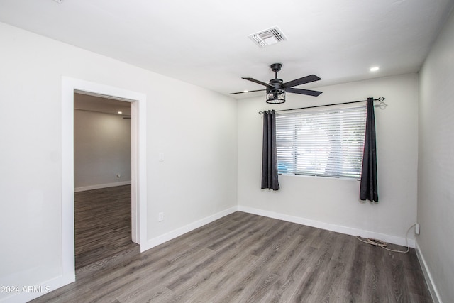 unfurnished room with ceiling fan and hardwood / wood-style flooring