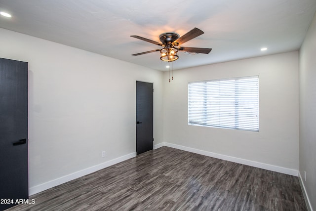 spare room featuring ceiling fan and dark hardwood / wood-style flooring