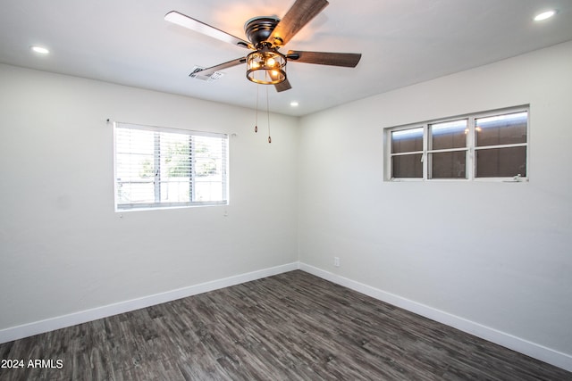 spare room featuring dark hardwood / wood-style floors and ceiling fan