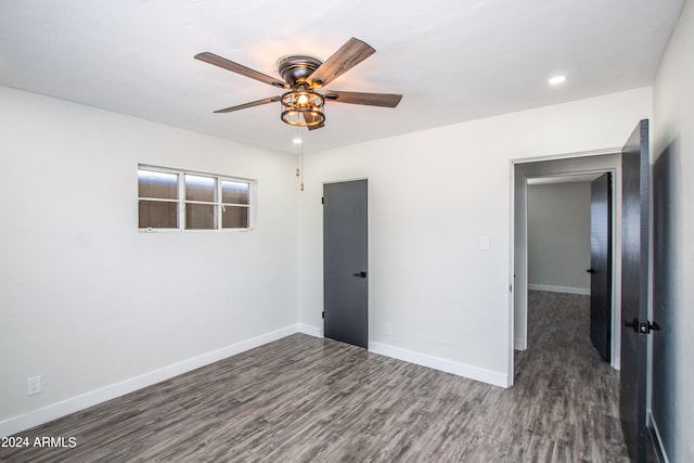 empty room featuring ceiling fan and dark wood-type flooring