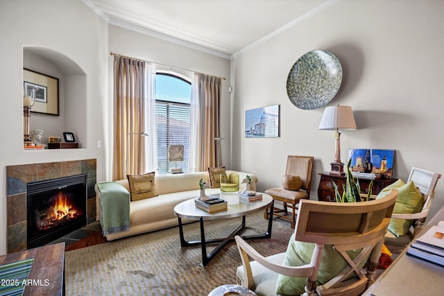 living area featuring crown molding and a tiled fireplace