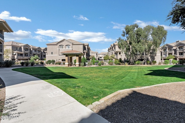 surrounding community featuring a yard and a residential view