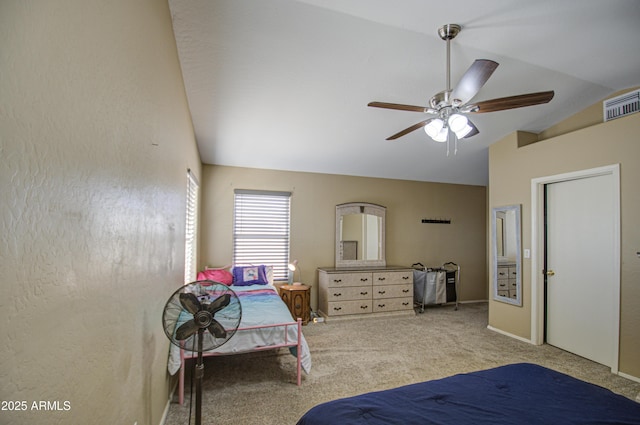 bedroom with visible vents, vaulted ceiling, a ceiling fan, and light colored carpet