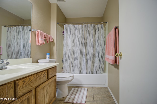 bathroom featuring toilet, visible vents, vanity, tile patterned floors, and shower / bath combo with shower curtain