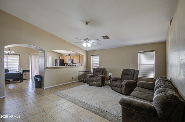 living area featuring lofted ceiling, plenty of natural light, visible vents, and light tile patterned flooring