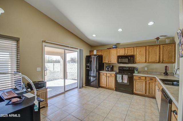 kitchen with light countertops, light tile patterned flooring, vaulted ceiling, a sink, and black appliances