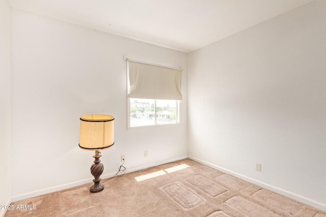 empty room featuring carpet floors and baseboards