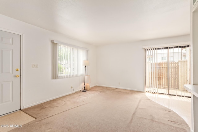 carpeted spare room with baseboards