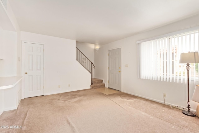 entryway featuring carpet floors, stairway, and baseboards