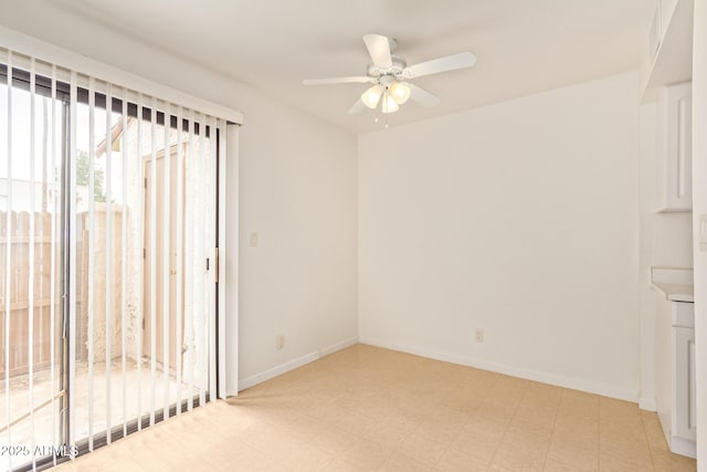 spare room with a ceiling fan, baseboards, and light floors